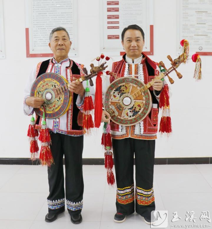 彝家男子身穿民族服饰弹四弦。